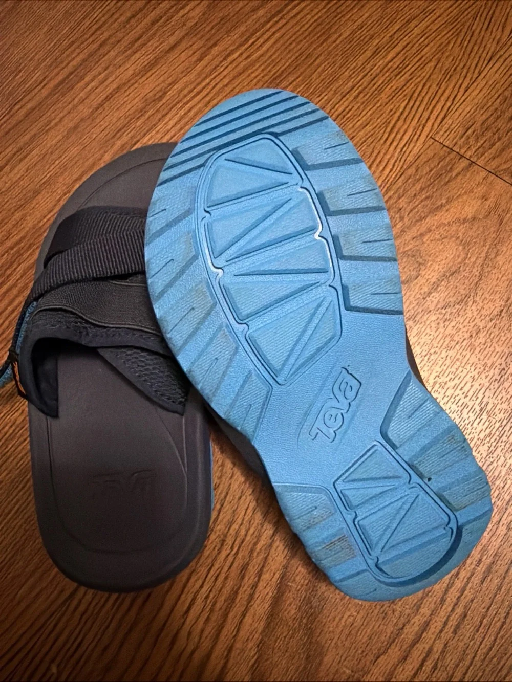 Teva Black Slide Sandals with Blue Accent